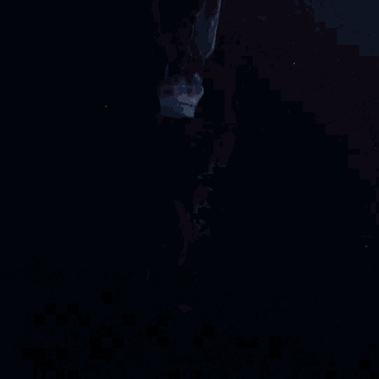 a person in a santa suit is flying through the air in the dark