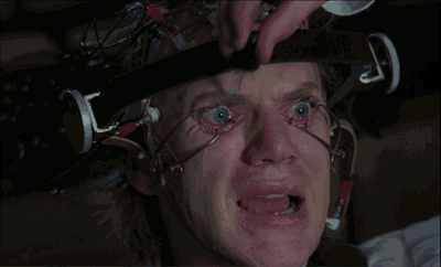 a close up of a man 's face with a device on his head that says ' t.i. ' on it