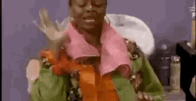 a woman is holding a pink towel around her neck .