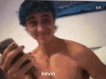 a shirtless man taking a selfie with the name kevin written on the bottom