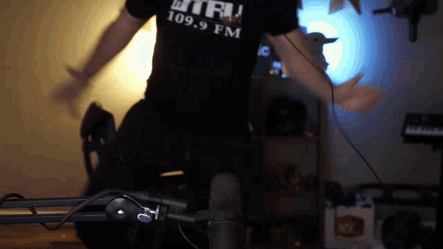 a man is wearing a shirt that says 109.9 fm on it