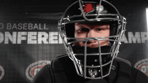 a man wearing a helmet with the word baseball behind him