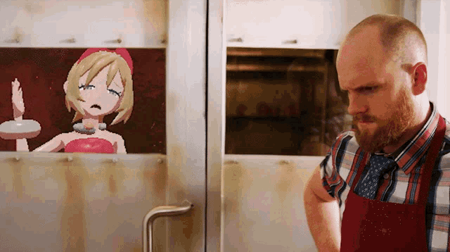 a man in a red apron is standing in front of a picture of a girl