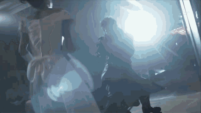 a man and woman are dancing in a dark room .