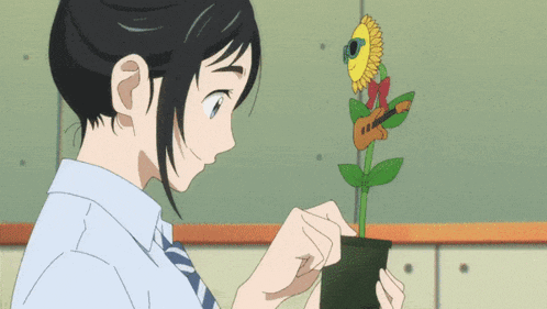 a girl is holding a potted plant with a guitar on top of it