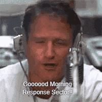 a man wearing headphones is talking into a microphone and saying `` good morning response sector '' .
