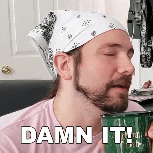 a man with a bandana on his head is holding a mug and saying damn it