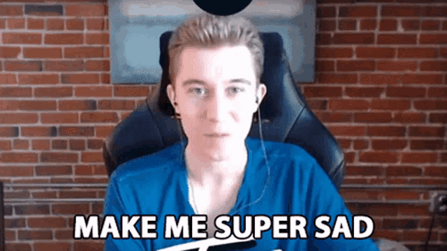 a young man sitting in a chair with the words make me super sad above him