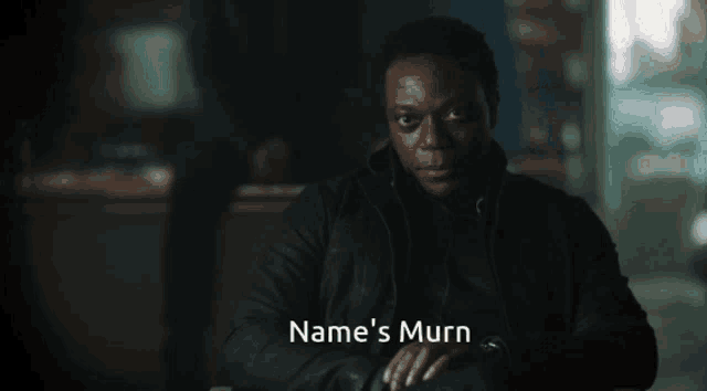 a man in a black jacket with the name name 's murn written on the bottom