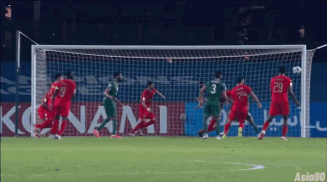 soccer players on a field with a sign that says konami
