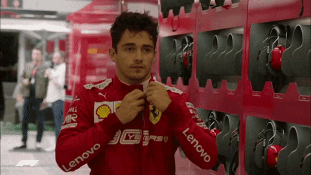 a man wearing a red jacket with lenovo written on it