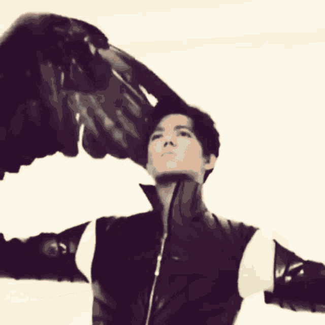 a man in a black and white jacket with wings spread out