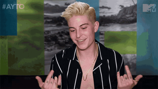 a shirtless man giving the middle finger in front of a mtv logo
