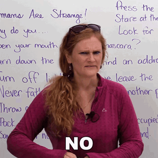 a woman stands in front of a white board that says press the store at the look for mascara