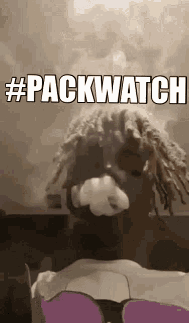 a man with dreadlocks smoking a cigarette with the words #packwatch written above him