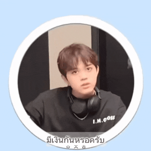a young man wearing headphones and a black shirt that says i.m. does