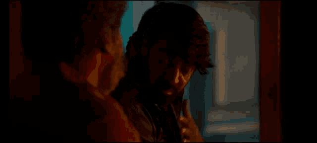 a man with a beard is talking to another man with the words " nenju adaikudhu pa enakku " on the bottom