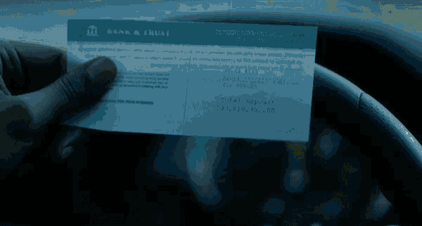 a person holding a bank and trust deposit receipt in their hand