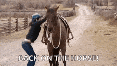 a woman is riding a horse down a dirt road .