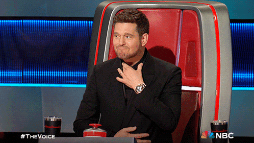 a man in a suit is sitting in a chair with a nbc logo on the bottom