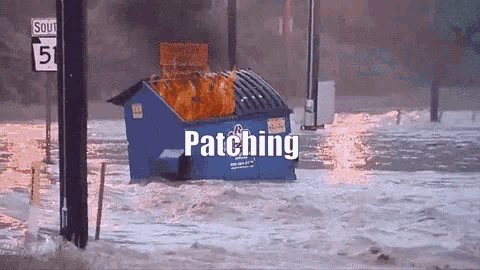 a dumpster is on fire in a flooded area and the word patching is visible