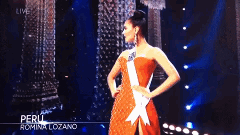 a woman in a red dress is on a stage with the name romina lozano