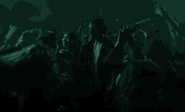 a man in a dark room with a blurred background