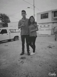 a black and white photo of a boy and a girl taken by candy camera