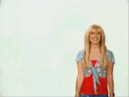 a woman with blonde hair is smiling in front of a white wall