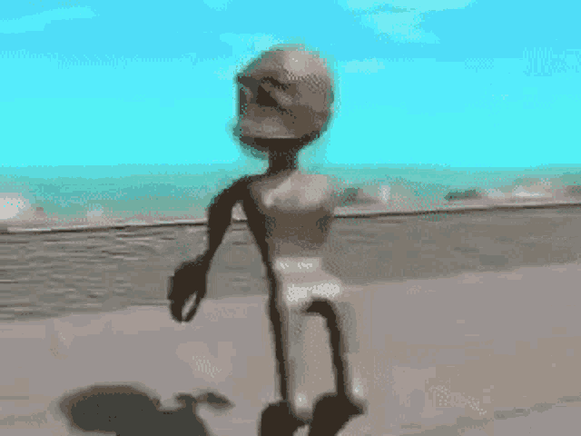 a cartoon character is walking on a beach with a helmet on .