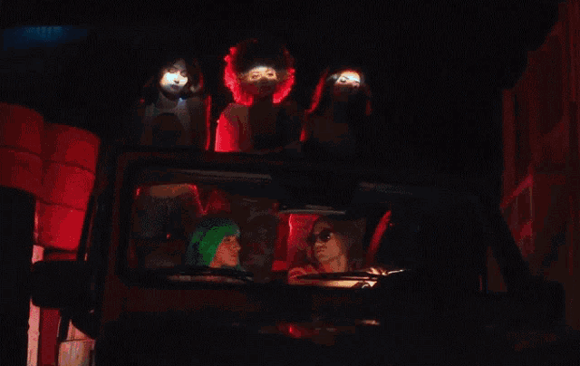 a group of women are sitting in a car with a man in the driver 's seat