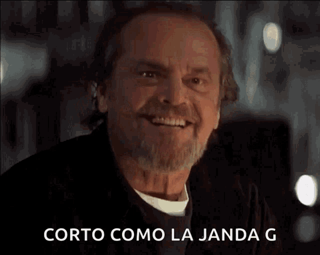 a man with a beard is smiling with the words corto como la jada g written below him