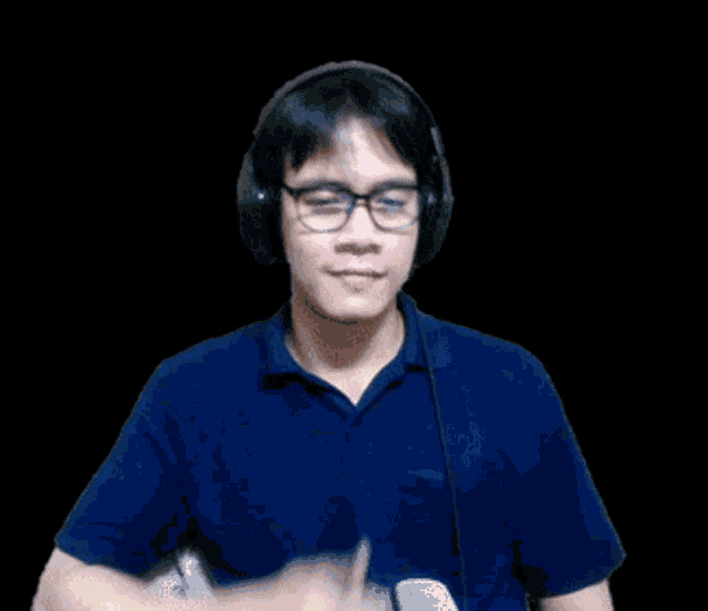 a man wearing headphones and glasses is smiling and giving a thumbs up