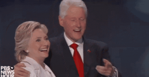 a man in a suit and tie is pointing at a woman in a white dress ..