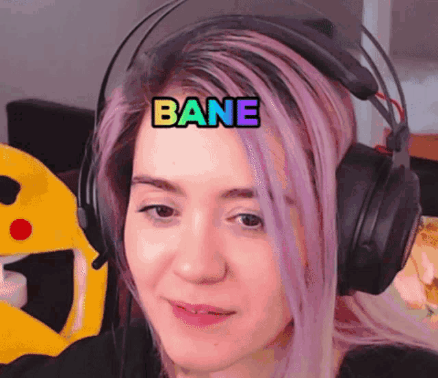 a woman with purple hair is wearing headphones with the word bane on her forehead