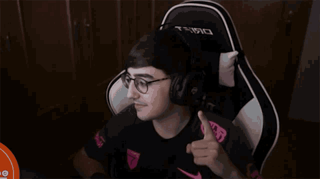 a man wearing headphones is giving a thumbs up sign