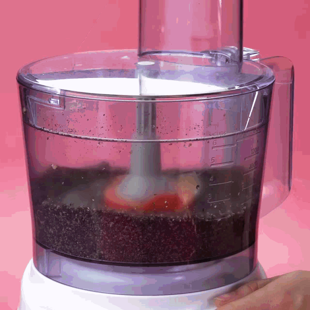 a food processor with a measuring cup that says 5