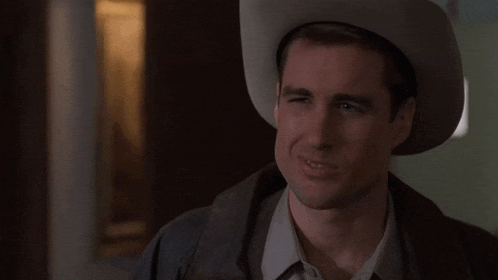 a man in a cowboy hat says y all must be the government people