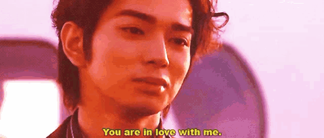 a close up of a man 's face with a caption that says `` you are in love with me '' .