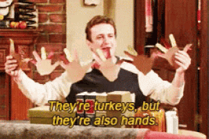 a man is holding turkeys in his hands and says they 're turkeys but they 're also hands .