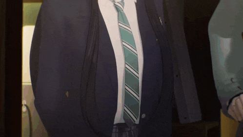 a man in a suit with a green tie