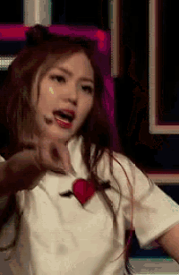 a woman wearing a white shirt with a heart on it