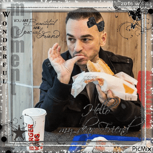 a picture of a man eating a burger next to a cup of burger king