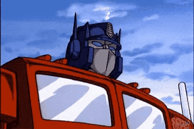 a cartoon of optimus prime looking out of a red truck