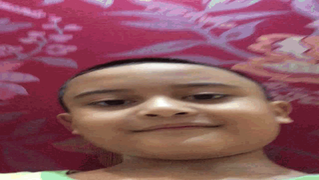 a close up of a child 's face with a floral background