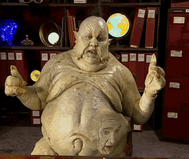 a statue of a man giving a thumbs up in front of red filing cabinets