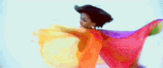 a woman in a colorful sweater is flying through the air with her arms outstretched