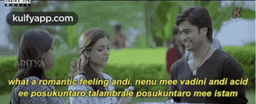 a man and two women are standing next to each other in a park talking to each other .