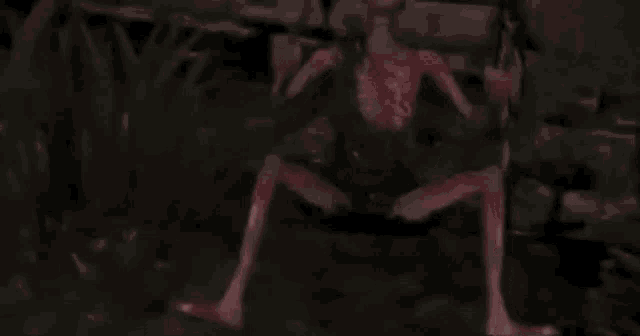a red monster is sitting on the ground holding a sword .