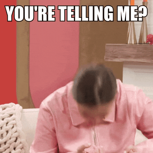 a woman in a pink shirt is sitting on a couch with the words you 're telling me behind her